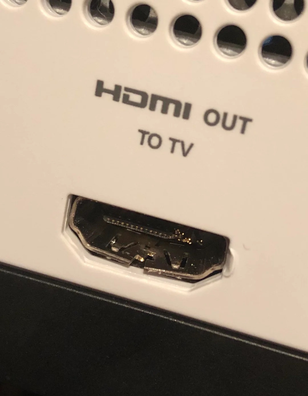 A close-up of a damaged console HDMI port